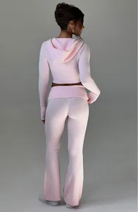 Vista posteriore di un completo in maglia rosa con felpa corta e pantaloni a zampa.
