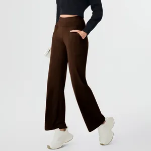 Side view detail of women's high-waisted straight leg yoga pants in chocolate brown.