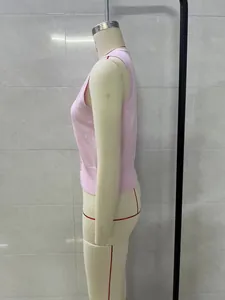 Side view of pink sleeveless knitted vest with button detail