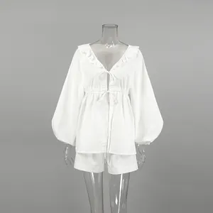 Detailed macro view of white linen-cotton set featuring puff sleeves and V-neckline