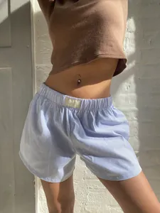 Detail view of women's blue striped high-waisted loose casual cotton shorts