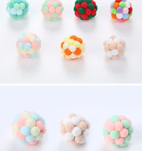 Macro view of colorful plush cat toy balls made of soft handmade pom-poms