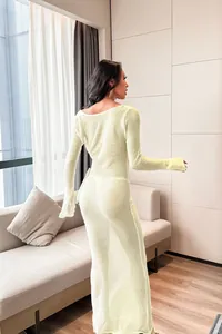 Full back view of a sexy long-sleeved sheer knit beach cover-up dress in pale lime green.