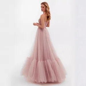 Elegant dusty rose tulle evening ball gown featuring a delicate lace-up corset back