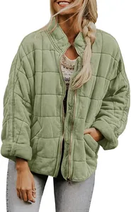 Close-up of light green quilted jacket with stand collar and zipper detail for women