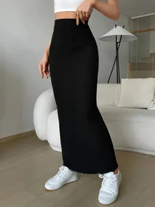 Elegant high waisted black ribbed knit maxi skirt with slim fit bodycon silhouette