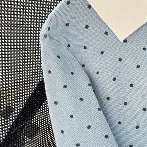 Light blue polka dot knitted cardigan sweater close-up