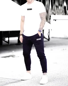 Close-up view of men's slim fit navy joggers featuring an athletic fit and logo