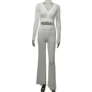White knit two-piece set with hollow crochet crop top and high waist flare pants