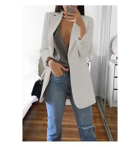 Mirror selfie view of a slim white blazer jacket for women in a casual indoor setting