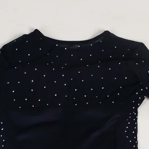 Close-up detail of a black mesh dress featuring sparkling heat-transfer rhinestones