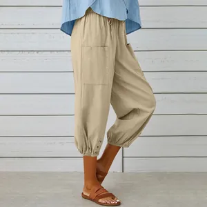 Detail of women's khaki cotton linen cropped pants with side pocket and button hem.