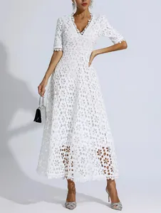 Full-length view of an elegant white lace maxi dress featuring intricate floral patterns