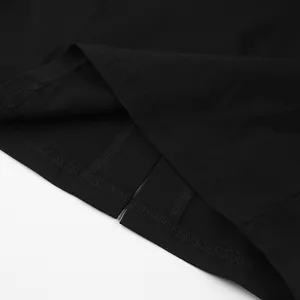 Detail close-up of the hemline and slit stitching on a classic black French dress