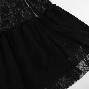 Detailed macro shot showing the intricate floral lace pattern and ruffles of a black dress.