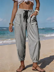 Detailed view of women's striped linen-like joggers with drawstring for beach vacation