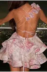 Detailed back view of a floral print mini dress featuring elegant criss-cross tie straps