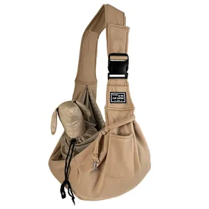 Detailed view of breathable khaki pet sling carrier with secure metal safety clip.