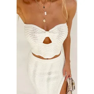 Detail view of the white wave-textured knitted tube top and matching mini skirt set