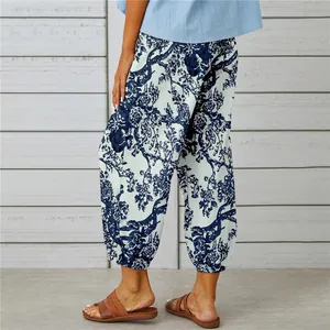Detailed view of floral pattern on white and blue cotton linen beam foot trousers