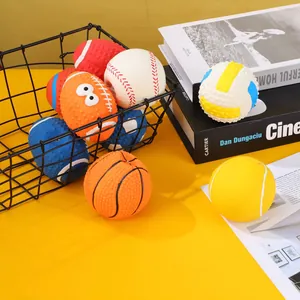 Close-up of various squeaky latex sports balls for dogs displayed in a wire basket