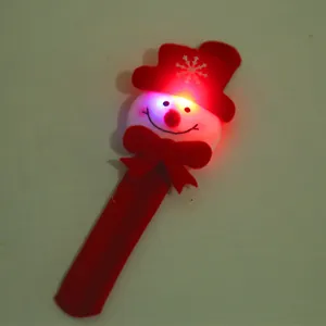 Detailed view of a glowing red Christmas slap bracelet featuring a cute snowman design