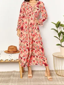 Full view of elegant floral print long-sleeved tiered maxi dress with V-neck ruffle detail