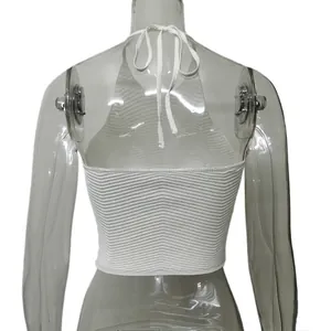 Back view of a white ribbed knit halter neck crop top with backless tie-up design