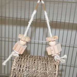 Close-up detail showing the texture of a woven grass bird nest with wooden blocks