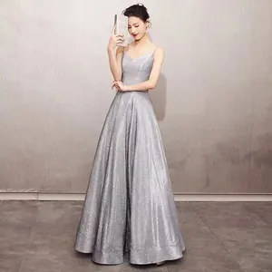 Full length view of an elegant silver glittery spaghetti strap evening gown for formal events