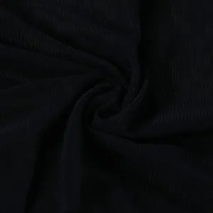 Detailed close-up view of the soft ribbed black knit fabric texture for evening dresses
