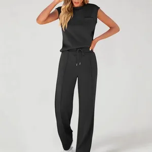Detail view of women's solid black two-piece set with sleeveless top and wide-leg pants