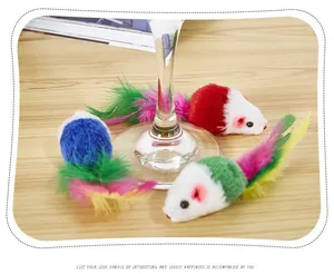 Detailed view of colorful plush mouse cat toys with soft feather tails on a wooden table