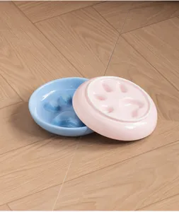 Durable ceramic paw print slow feeder pet bowl in blue and pink colors for cats and dogs