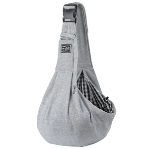 Close-up of adjustable grey pet sling carrier featuring checkered lining and safety buckle.
