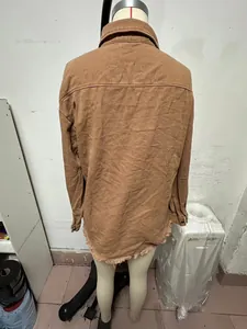 Detailed back view of women's brown washed denim shirt jacket with trendy frayed hemline