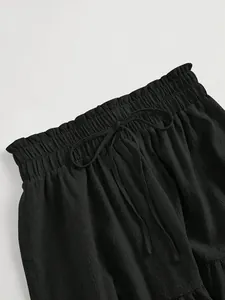 Close-up of elasticated ruffle waist with drawstring on black plus size skirt