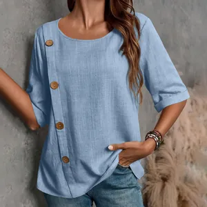 Dettaglio di un top casual in cotone e lino blu con grandi bottoni decorativi in legno e scollo.