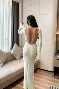 Detailed back view of a sexy light green backless long-sleeved beach cover-up dress