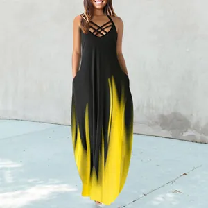 Close-up of a black sleeveless maxi dress featuring a yellow flame print and halter neck