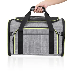 Breathable grey pet carrier bag with lime green trim held by the padded top handle