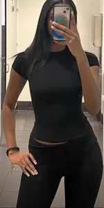 Detail view of a black two-piece sports set featuring a slim-fit crew neck T-shirt