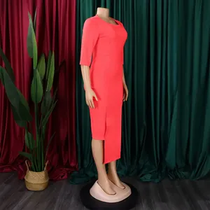 Side view of elegant coral office dress featuring asymmetrical split hem and 3/4 sleeves