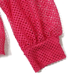 Dettaglio del polsino della manica lunga in rete rosa acceso che mostra la trama