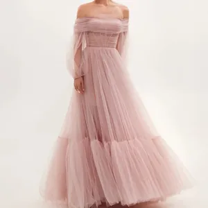 Detailed view of elegant pink off-the-shoulder tulle gown with long puffed sleeves