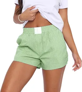 Detail of women's green striped cotton lounge shorts with elastic waistband.