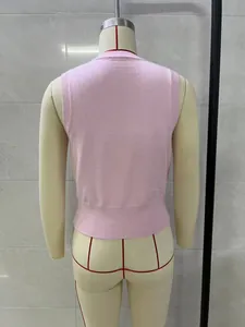 Back view of a stylish pink summer sleeveless knitted vest top displayed on a mannequin