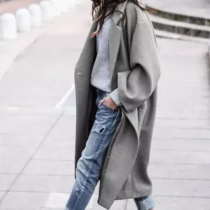 Detailed view of the long grey woolen coat featuring a relaxed fit and warm texture