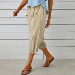 Detail of women's khaki linen cropped pants with drawstring waist and buttoned hem.