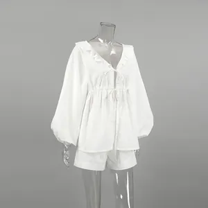 Detailed view of a white cotton linen V-neck puff sleeve top and matching shorts two-piece set